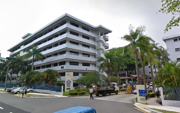 The driveway entrance of 1092 Lower Delta Road, showing the building sign and the way in to the car park